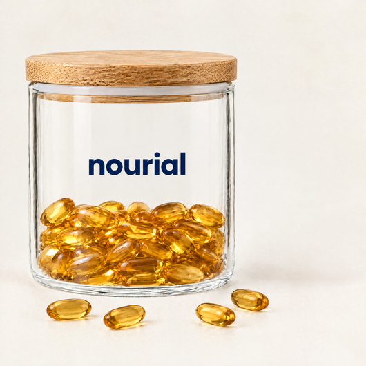 Nourial glass jar with bamboo lid, partly filled with amber softgels