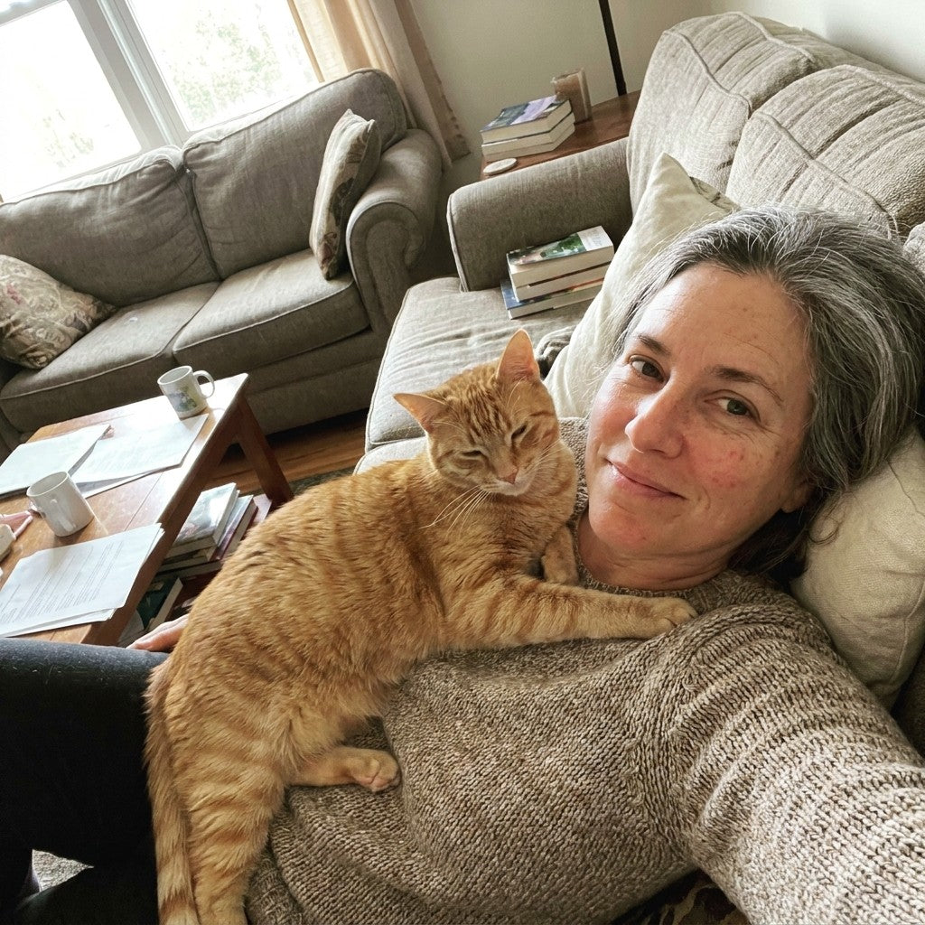Baxter the orange tabby resting on Debra’s shoulder